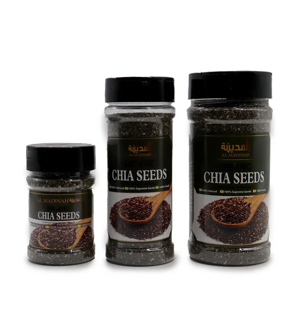 Biji chia (chia seeds) kemasan botol dari merek Al Madinah, ditampilkan dalam tiga ukuran berbeda dengan warna hitam alami dan label produk khas Timur Tengah.